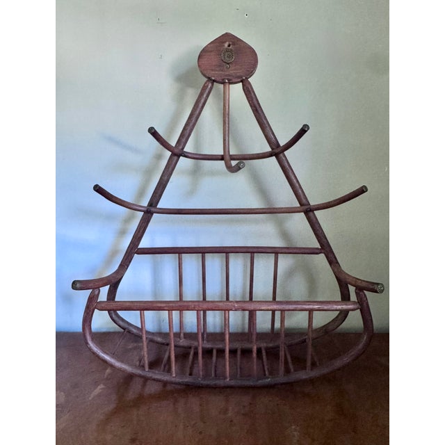 This vintage bentwood hat and coat rack includes a uniquely designed "cage" for gloves and scarfs, and is accented by...
