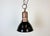 Industrial black enamel factory pendant light made in Italy during the 1950s. White enamel inside the shade. Iron top in...