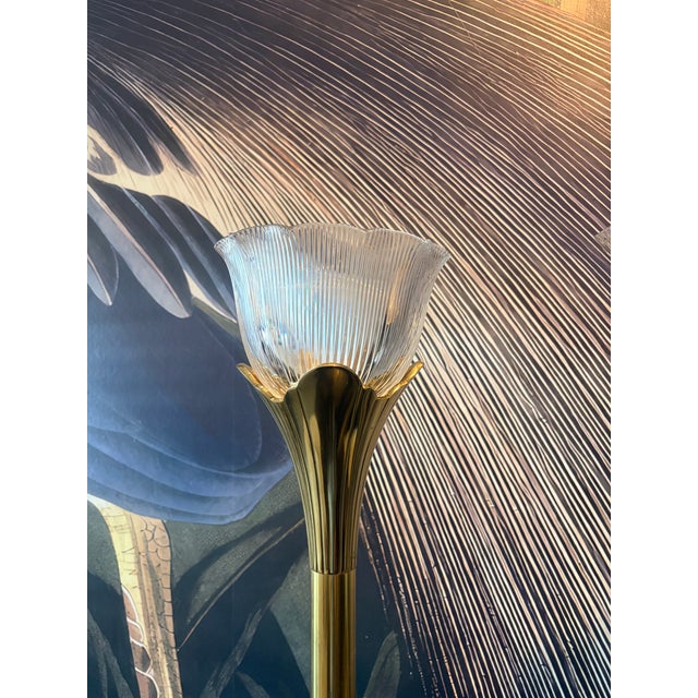 Elegant pair of vintage Stiffel brass tulip floor lamps featuring sculptural fluted brass stems, petal-form fittings, and...