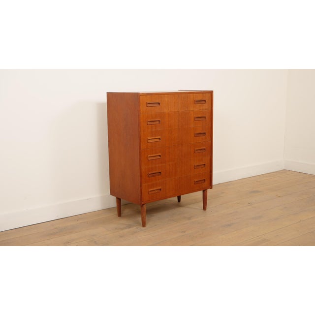 This stylish vintage chest of drawers is a wonderful example of mid-century Danish furniture. Crafted from warm teak, this...