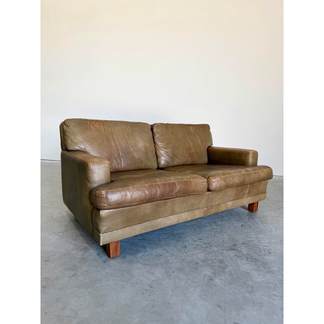 Handsome classic Olive buffalo Leather Loveseat styled after the Mexico sofa by Arne Norell Sweden, c.1960’s. Beautifully...