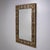 Rectangular wall mirror in a brass frame, designed by Luciano Frigerio in the 1970s. The decorative cast brass surround is...