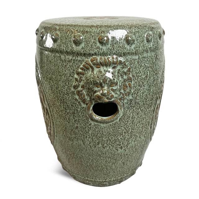 Ceramic sea green garden stool with medallion cutout design on one side and lion on the other. Features beautiful green...