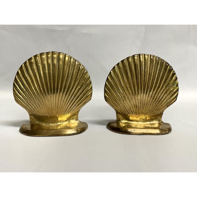 A pair of vintage brass clam shell bookends from the 1970s. The brass bookends would be perfect for coastal or beach house...