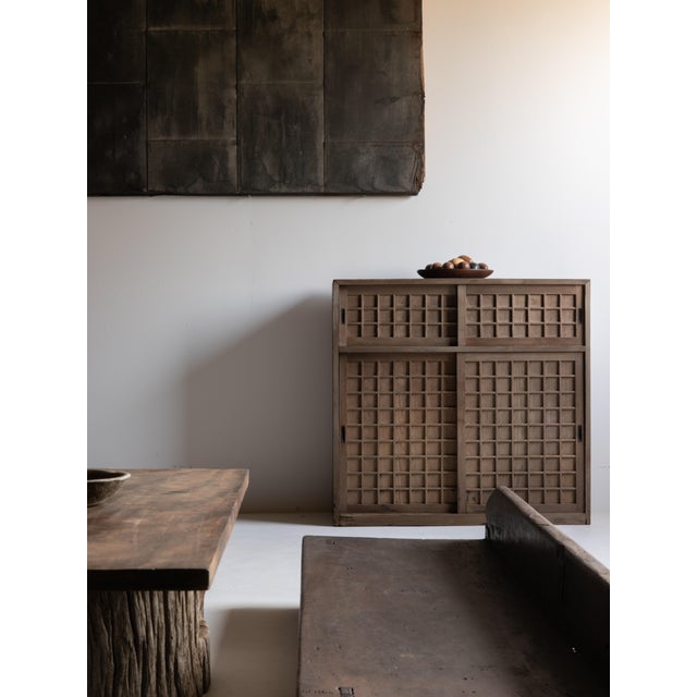 This Japanese tansu cabinet was crafted during the late Meiji to Taisho period and is made from solid cedar wood. It...