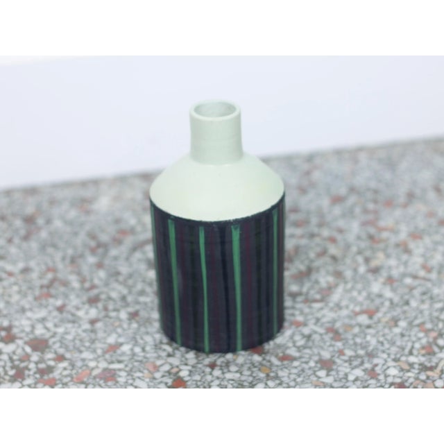 A small ceramic vase or bottle with green and purple pinstripe glaze designed by Ettore Sottsass for Bitossi. Aquired from...