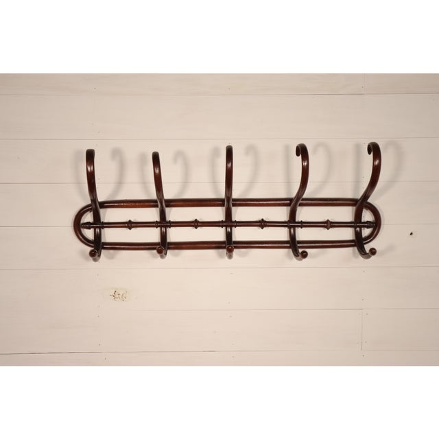Elegant vintage French Mahogany coat rack style wall hanger. It is in good vintage condition overall with some small wear...