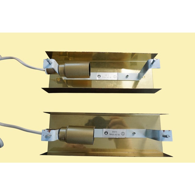 A pair of decorative wall sconces with textured glass shades and a simple brass body, model number 8971, likely made in...