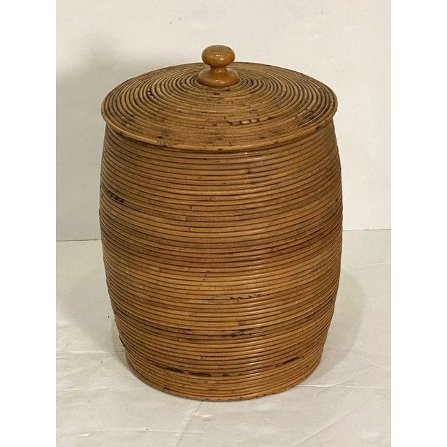 A fine large French basket container featuring a removable round top lid with wooden finial set upon a cylindrical body of...