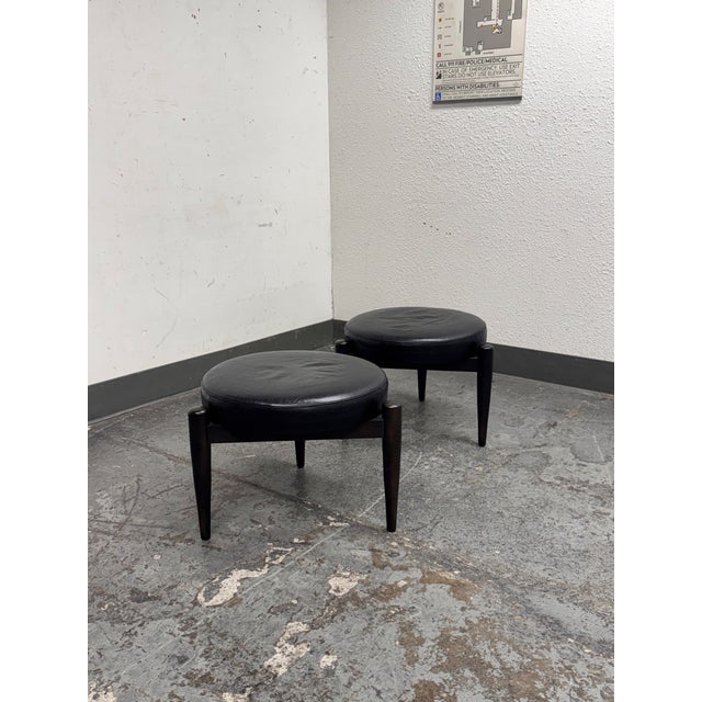 Design Plus Gallery presents a Pair of Murphy Leather Ottomans from Room & Board. The ottomans showcase rounded leather...