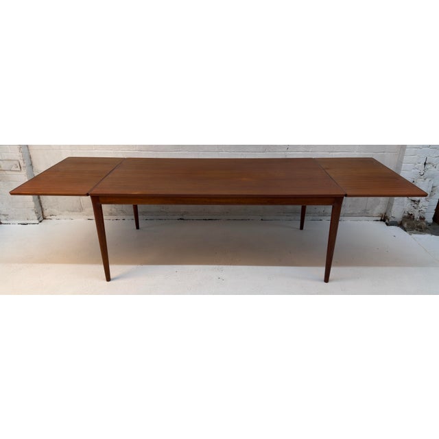 Vintage Danish Mid-Century Modern Teak Expandable Dining Table. Expertly crafted, this piece perfectly embodies the...