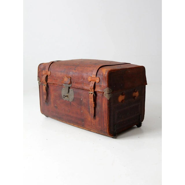 This antique leather trunk by George Burroughs & Sons, dating to the late 1860s, features a richly tooled brown leather...
