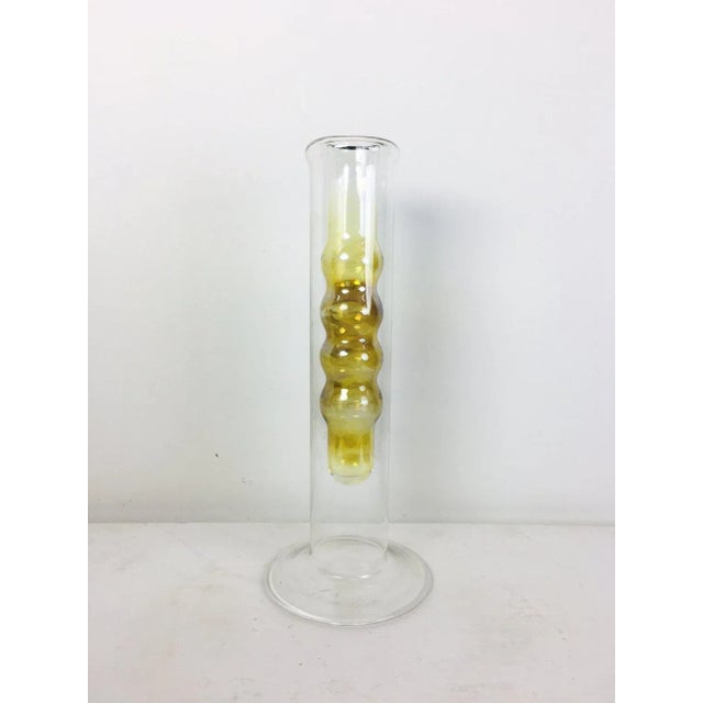 A vase decorated with a bright yellow spherical interior wall. Made in the 1970s. Dimensions: 32x13x13cm