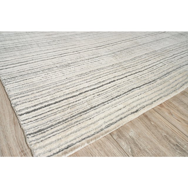 The Rossini rug was designed to ground any room with its lush softness, rich dimensional texture and striated design. Made...