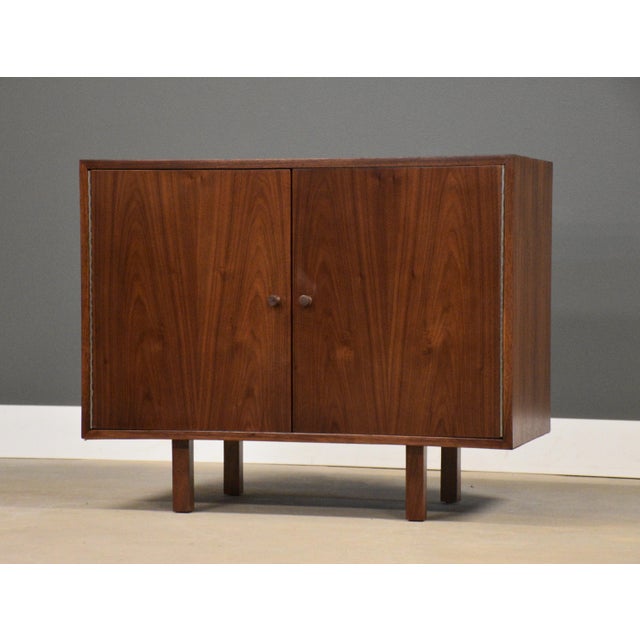 A mid century modern walnut credenza two door chest with walnut knobs. Professionally refinished. Circa 1960’s. Made in...