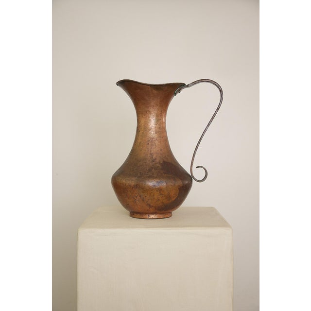 Large Vintage Copper Pitcher with Curled Handle Shows signs of patina