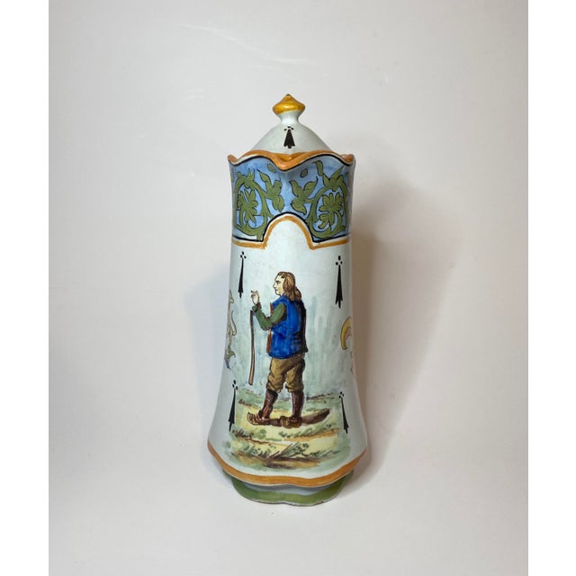 A rare Desvres French faience chocolate pot with lid in the style of Porquier Beau Quimper. It features a hand painted...