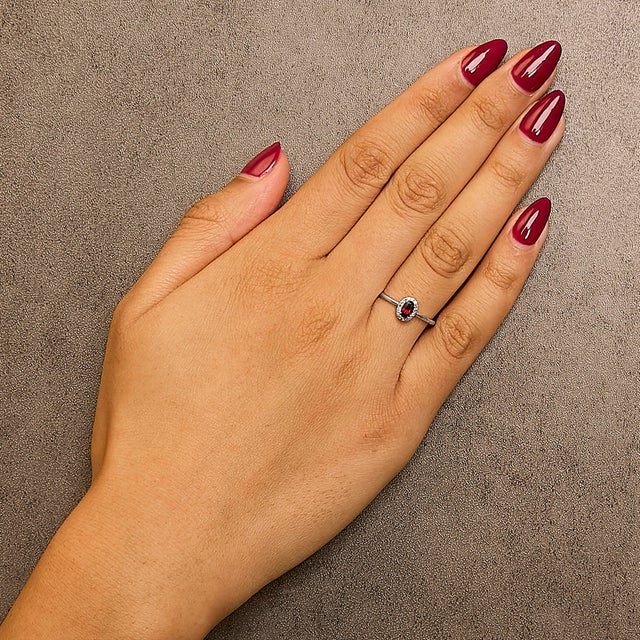 Elegant and radiant, this exquisite ring is a symphony of color and light, masterfully crafted from rhodium-plated 10K...