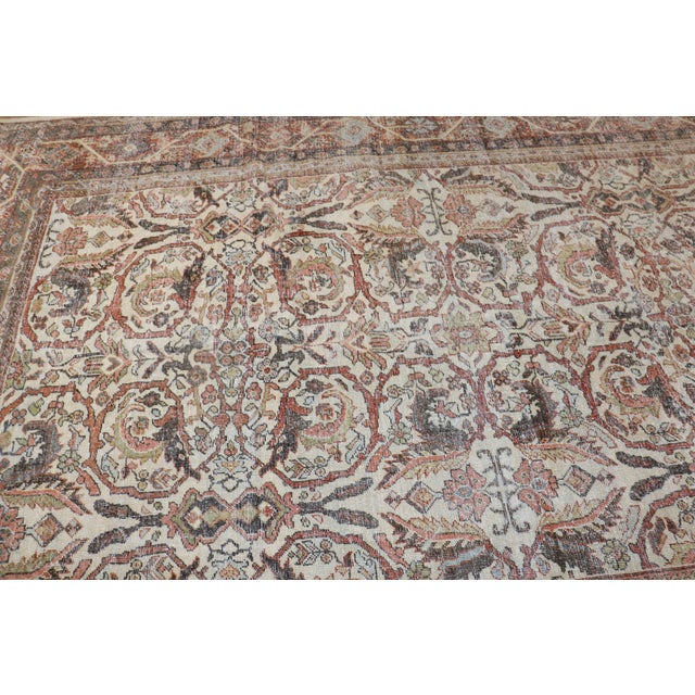 A one-of-a-kind Persian Mahal worn rug featuring an ivory ground with a bold, masculine pattern from the 1st quarter of...