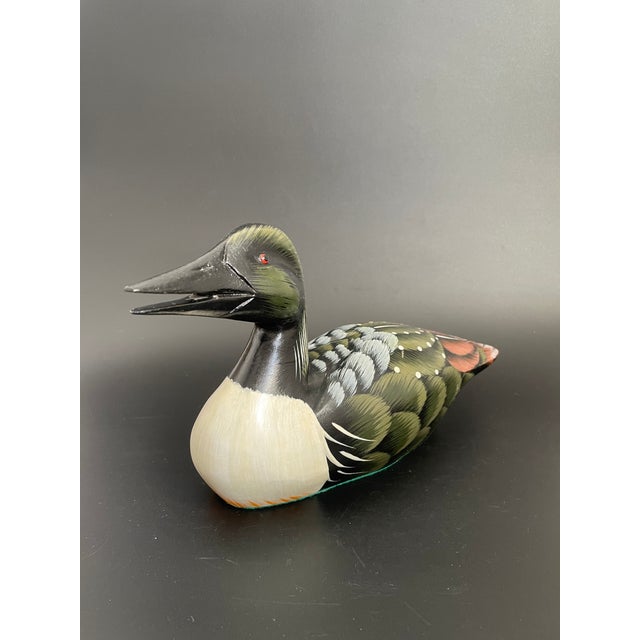 A vintage artisan crafted Common Loon decoy. Hand carved and hand painted with intricate details. Nice condition with...