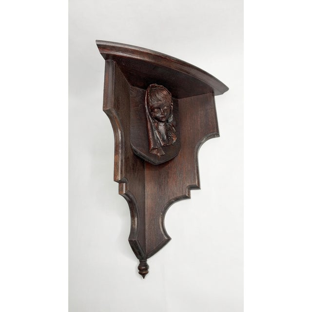 This exquisite 19th-century walnut corner wall shelf features a beautifully hand-carved maiden's face in high relief. The...