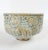 Contemporary hand thrown studio stoneware pottery bowl. Light blue and taupe glaze with raised abstract design. Unsigned.