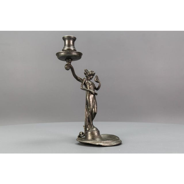 French Art Nouveau style pewter candlestick with a sculpture of a lady, from circa 1920. An elegant Art Nouveau candle...