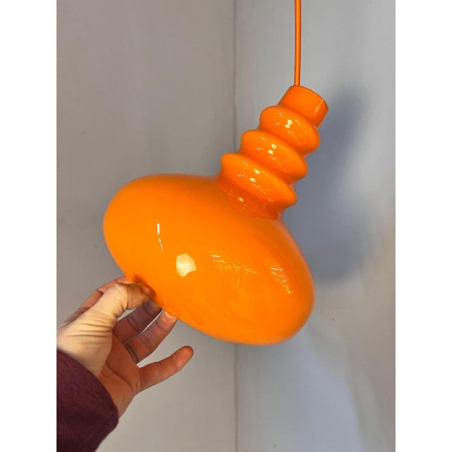 This pendant lamp by Peill & Putzler is an exquisite example of German glass art from the Space Age era. with its playful...