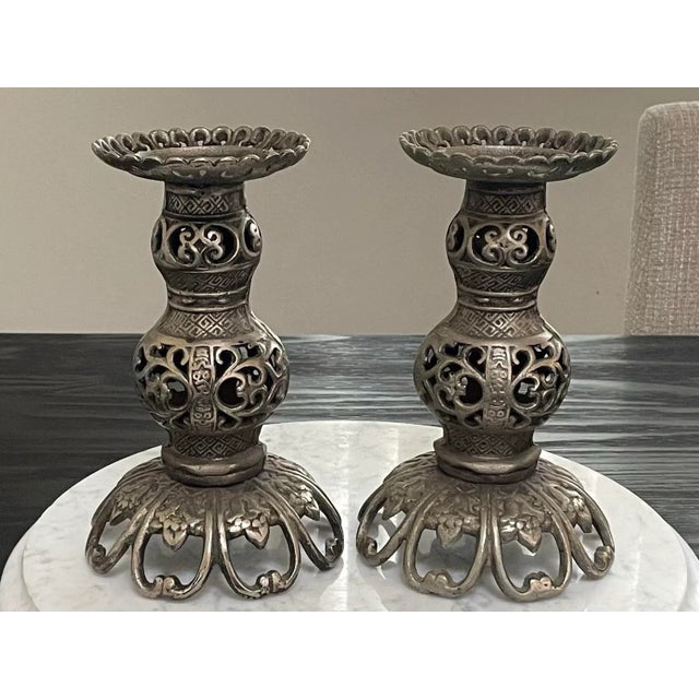 Intricate James Mont style pierced Iron Japanese candle holders. These Mid 20th Century heavy weighted candle holders will...
