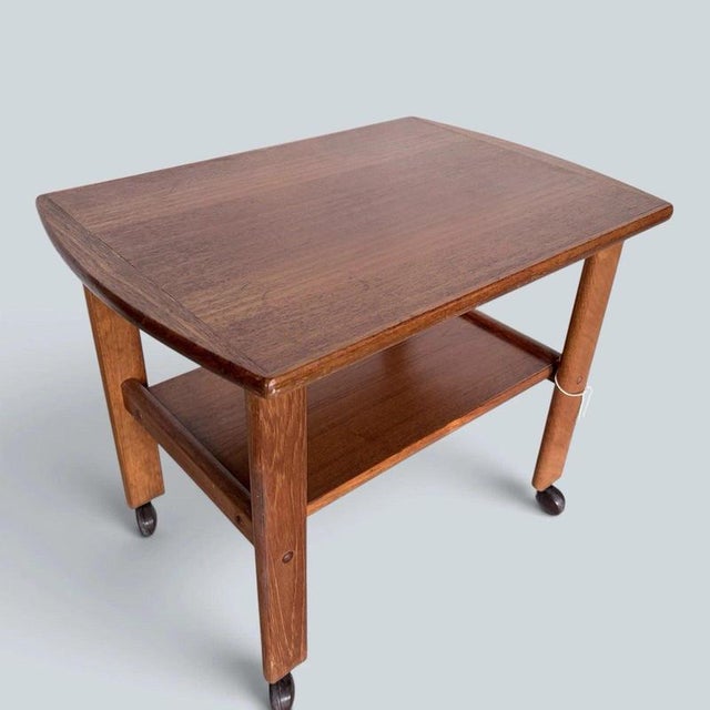 a compact danish teak drinks trolley by brdr. Furbo, combining clean mid-century lines with practical two-tier storage....
