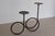 A sculptural vintage wrought iron candleholder, made in Mexico, featuring a fluid looping form with two elevated candle...