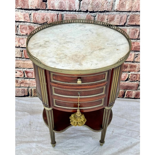 French 19th Century Napoleon III Oval Marble Top Side Table. Table has an oval form with a three quarter brass gallery...