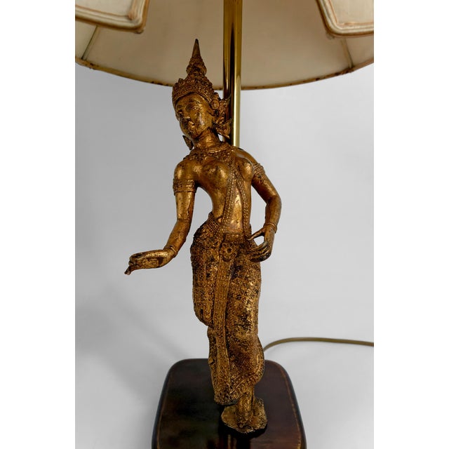 Pair of Sculptural Lamps in Gilded Bronze Representing Dancers, Thailand, 20th Century. Add a touch of refinement and...