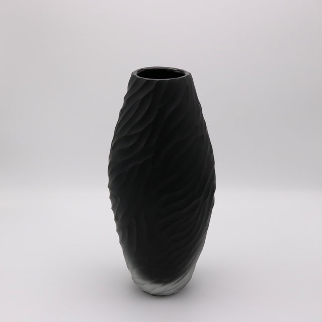 A contemporary Italian Murano Art Glass vase from Italy circa 1990. The hand molded tinted matte black glass with deep...