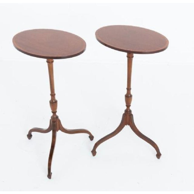 Pair of Georgian revival mahogany wine tables. Circa 1920 The tables feature oval tops with satinwood crossbanding. Will...