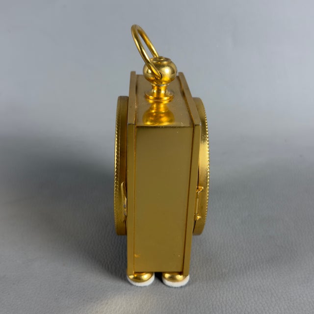 Visually striking and with a significant weight, this refined table and desk clock is crafted from heavy gilded brass with...