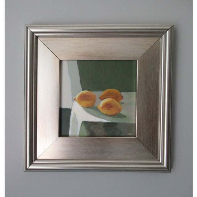Afternoon sunlight softly falling across lemons on a table. A sheer curtain behind the table. This painting has a Dutch...
