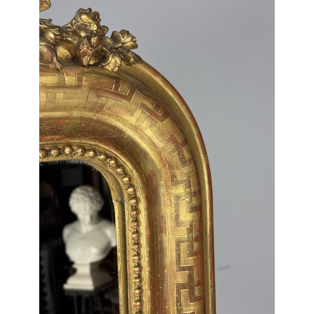 Louis Philippe Gilded Mirror, 19th Century. Originating from France, this 19th-century mirror is fully gilded, surrounding...