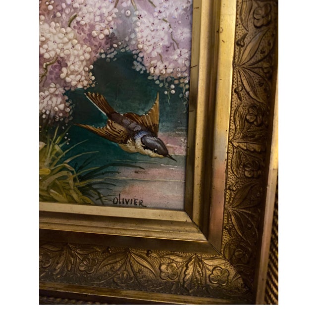 A gorgeous hand painted porcelain tile in original giltwood frame. The tile with hand painted blue birds and wildflowers...
