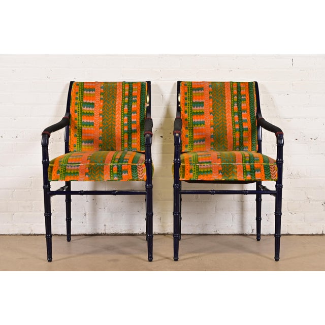 A gorgeous pair of mid-century Hollywood Regency armchairs or club chairs USA, Circa 1970s Ebonized bamboo form walnut...