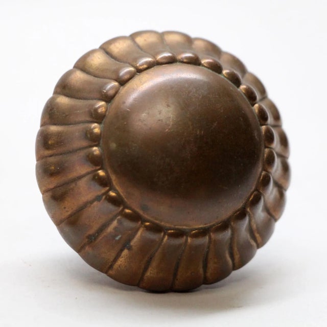 Decorative radial design bronze door knob. Manufacturer and date of creation is unknown. One single available. The...