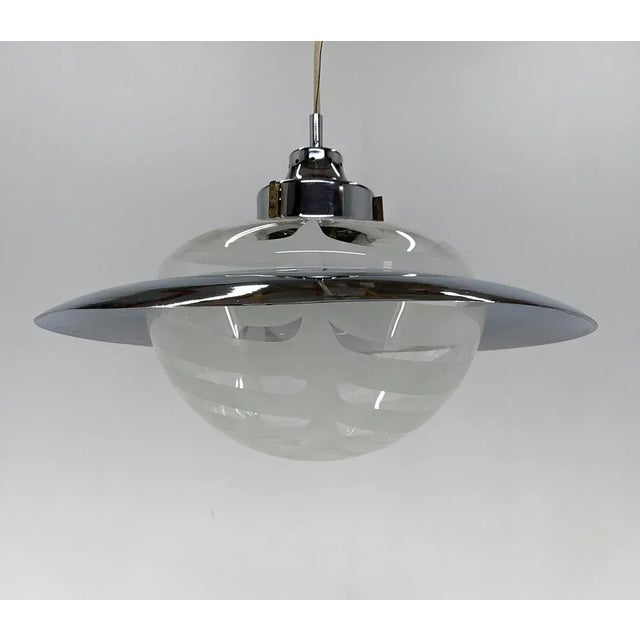 Beautiful chandelier made in Italy in the 1970's. The chandelier/pendant is made of Murano glass and chrome, resembling...