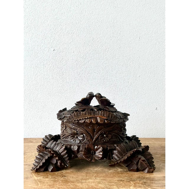 This exceptional Black Forest hand-carved casket box is a masterpiece of rustic European artistry. Crafted from dense,...