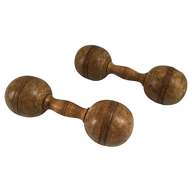 Pair of antique tow pound turned wood dumbbells. No maker's mark. Great for coffee table display. Condition: surface age...