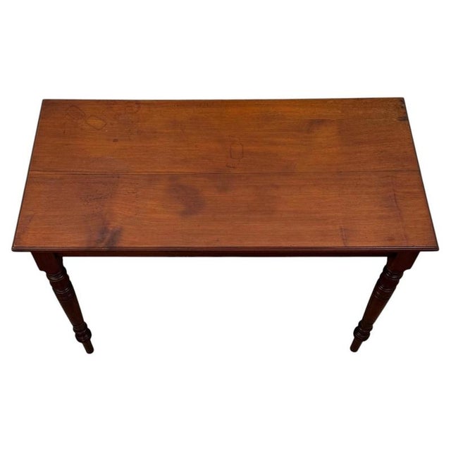 A handsome and finely crafted early 20th-century English Edwardian side table, beautifully constructed in walnut and...