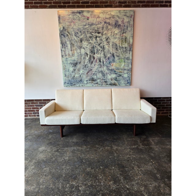 Absolutely stunning Hans Wegner Teak sofa reupholstered in an Ivory woven Chenille model GE 236 Box springs cushions were...