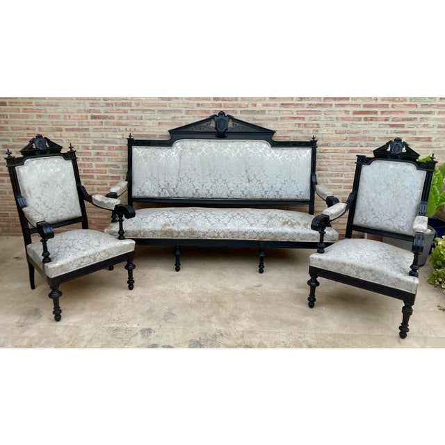 Set of Alphonsine Armchairs in ebonized wood, ca.1900. Back with pediment plume and shield inside. a style that stood out...