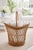 beautifully crafted vintage wicker basket featuring an elegant open lattice weave and gracefully arched double rim. The...