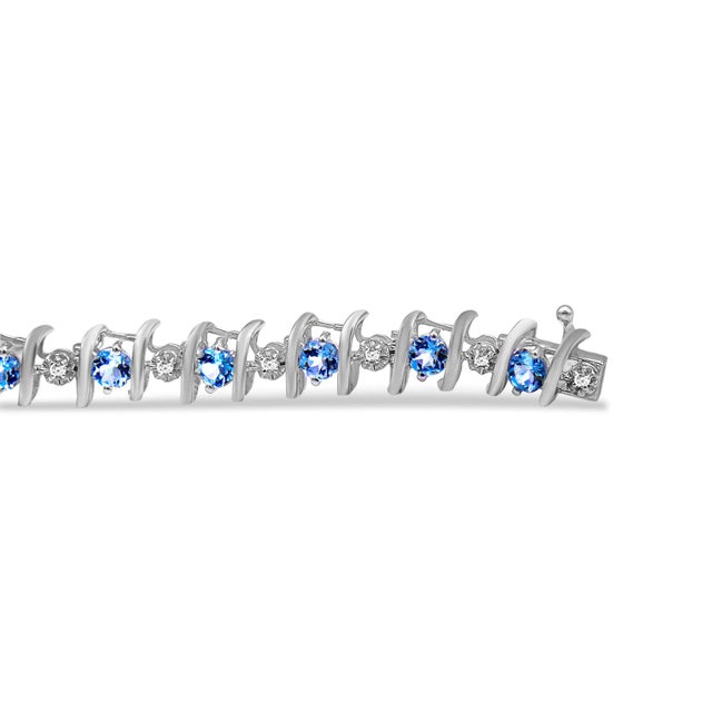 Vivid created birthstones and sparkling white diamonds are set in this S-link tennis bracelet crafted in cool .925...