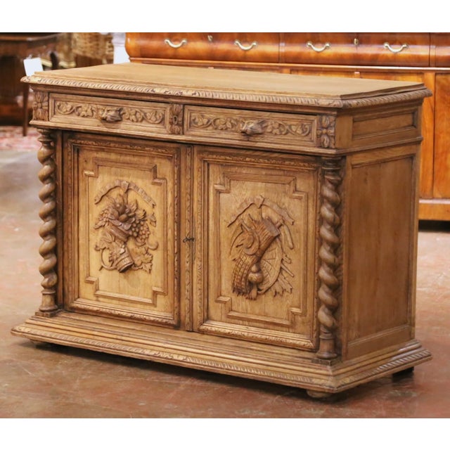 Richly carved with symbols of the harvest and rural life, this impressive antique buffet would bring warmth, architectural...